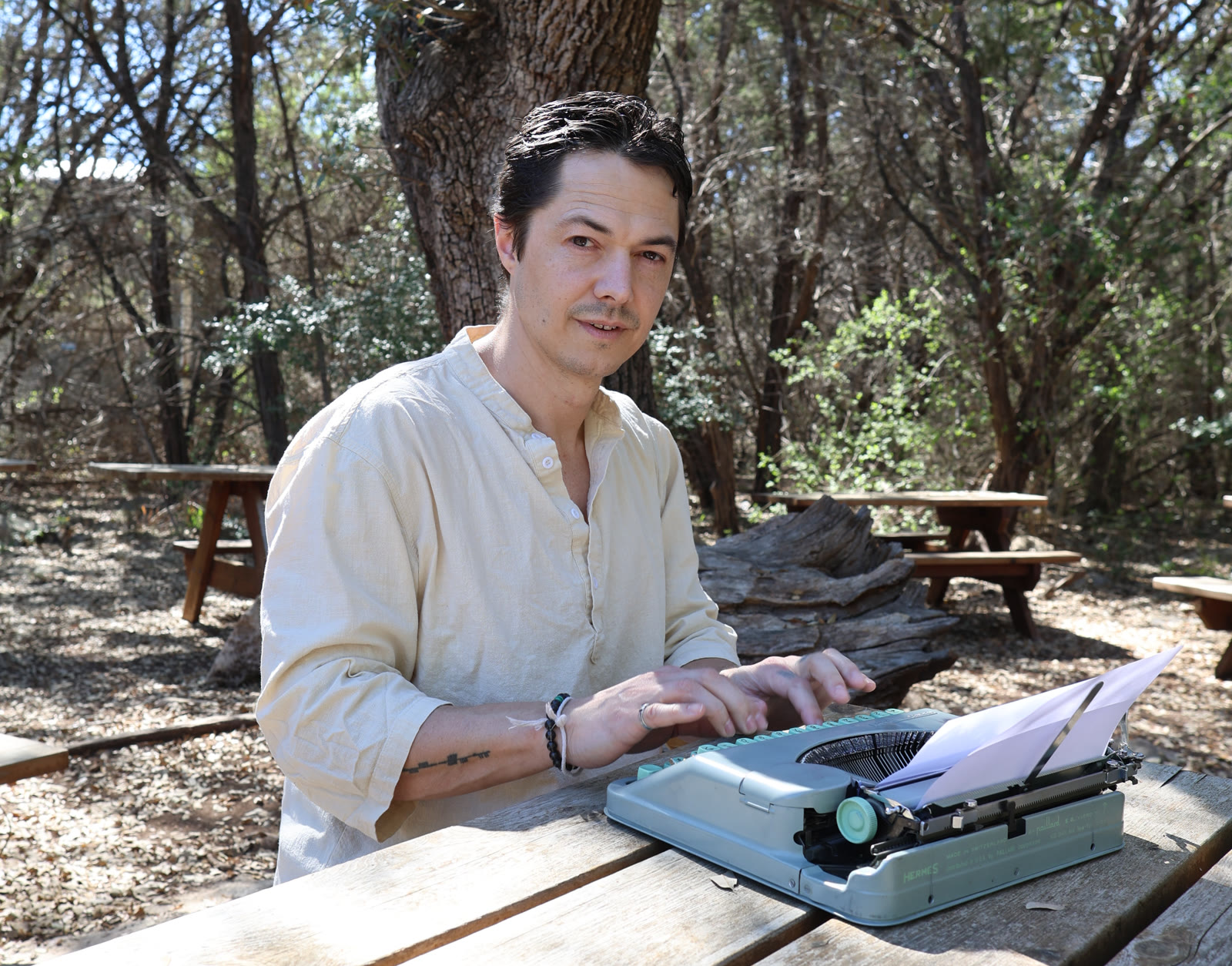 Stephen Lloyd Webber writing outdoors